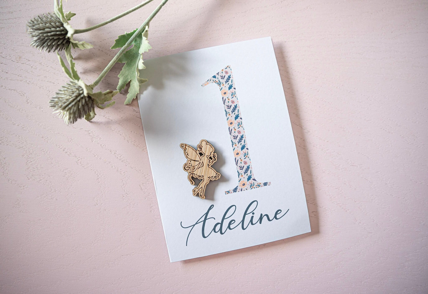 Celebrate a 1st birthday with our Personalized Card featuring a charming wooden charm. Perfect for a unique and heartfelt gesture.