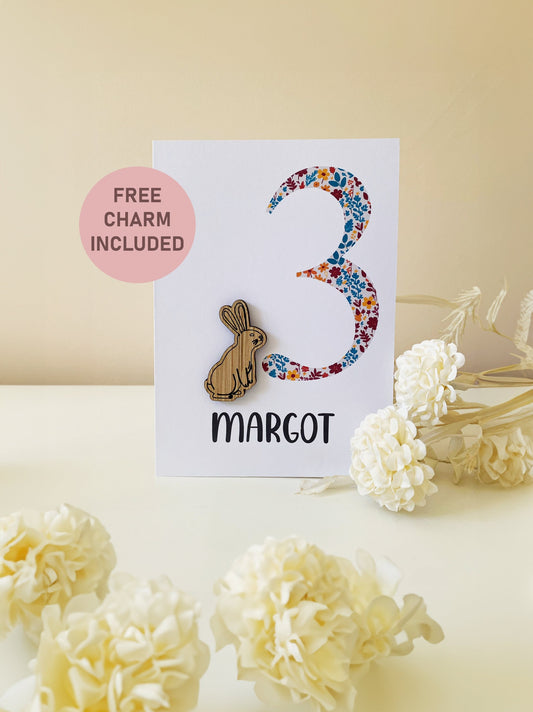 Celebrate a 1st birthday with our Personalized Card featuring a charming wooden charm. Perfect for a unique and heartfelt gesture.